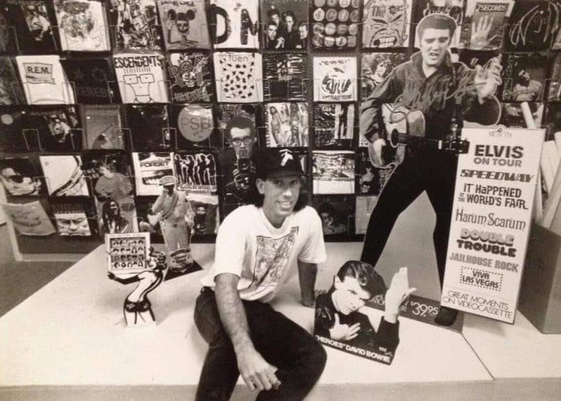Yesterday & Today Records and Y&T Music founder Rich Ulloa atop a display case inside his record store at the Red Bird Shopping Center in the early 1990s. The store was at the mall from 1991 to 1995 and hosted in-store appearances by The Mavericks, Soundgarden, Mary Karlzen and Fishbone.
