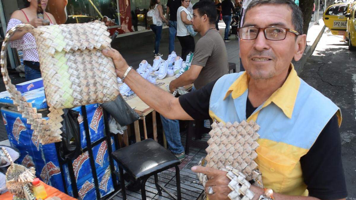One thousand Venezuelan bills went into making the purse being held up by Alvaro Rivera in Cúcuta, Colombia. As Venezuela's bolivar has lost its value, artisans say it's worth more as a raw material than as a currency.