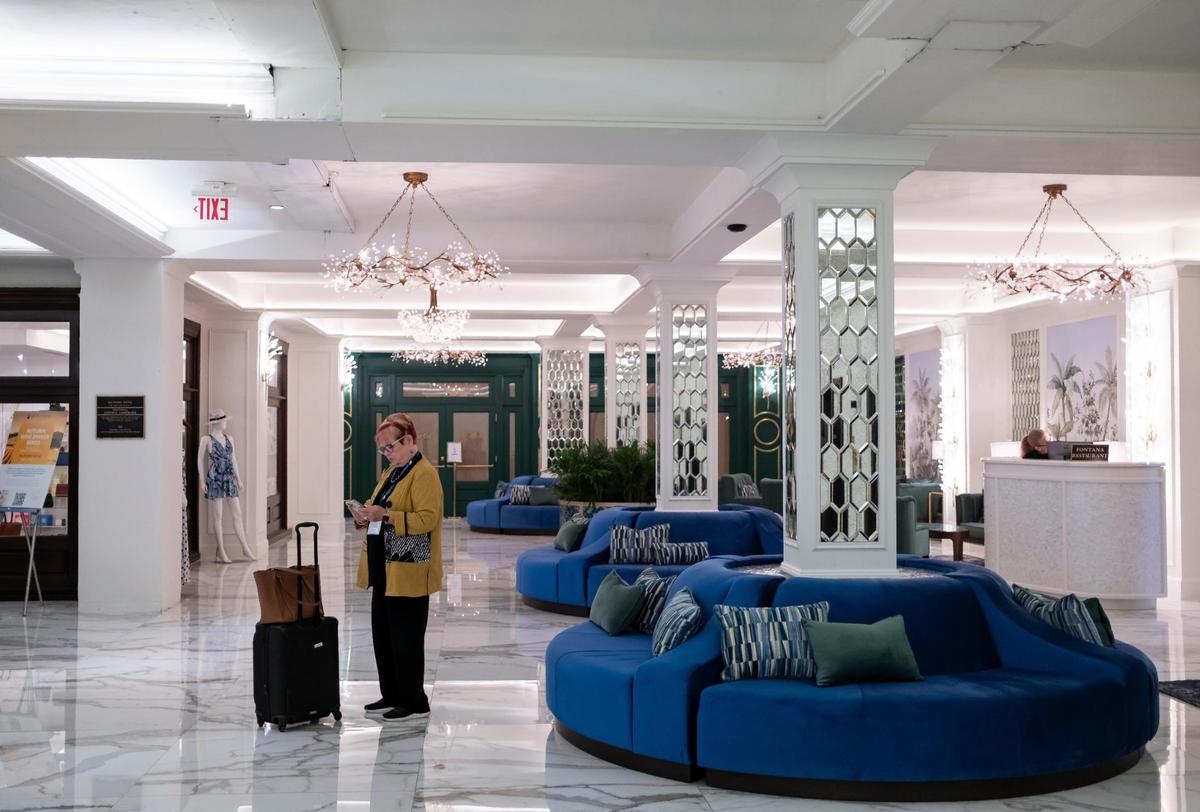 A guest stands in the remade lower lobby of the historic Biltmore Hotel. Coral Gables officials halted renovations at the city-owned hotel’s ground floor that stripped off or covered up historic features with white paint, marble flooring and mirrors after discovering the work was being done without permits.
