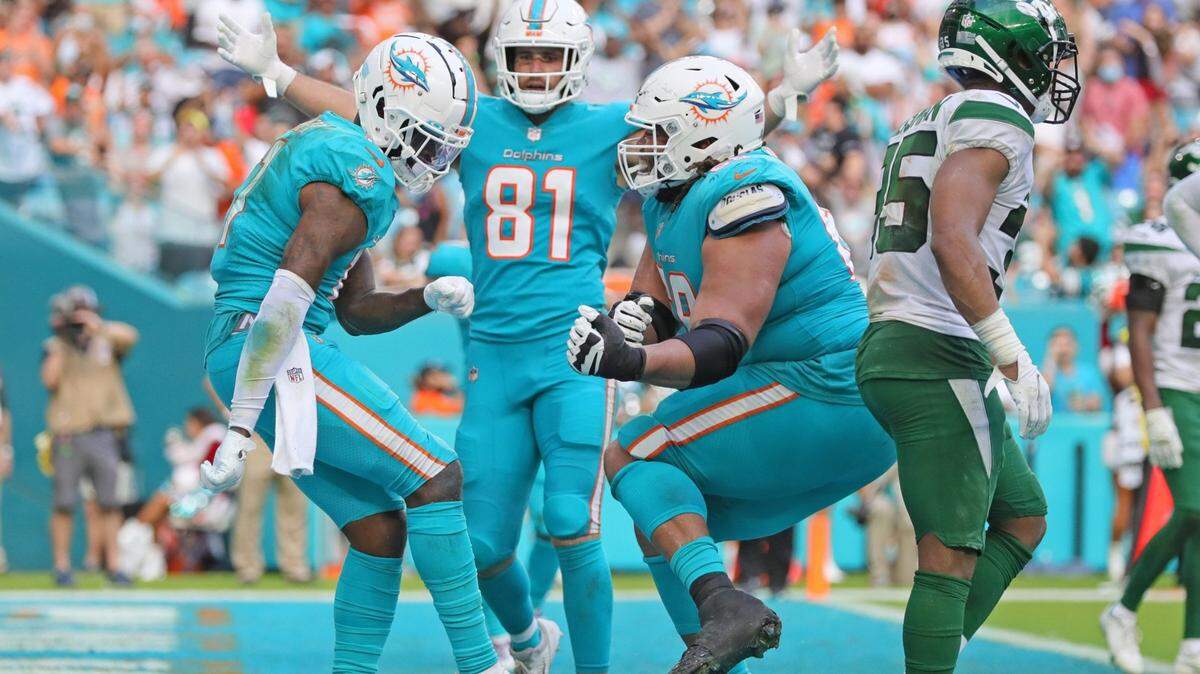 Miami Dolphins wide receiver DeVante Parker (11) celebrates with guard Robert Hunt (68) and tight end Durham Smythe (81) after scoring in the the fourth quarter on a reception from quarterback Tua Tagovailoa (1) against the New York Jets at Hard Rock Stadium in Miami Gardens on Sunday, December 19, 2021.