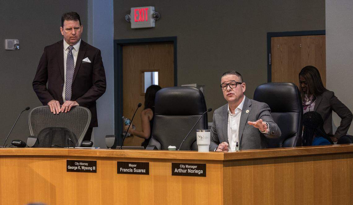 City Attorney George K. Wysong III (left) listens as City of Miami manager Arthur Noriega announced the cancellation of the special meeting called due to the lack of quorum, to send two referendums to the November ballot, at City Hall, on Friday September 05,2025.