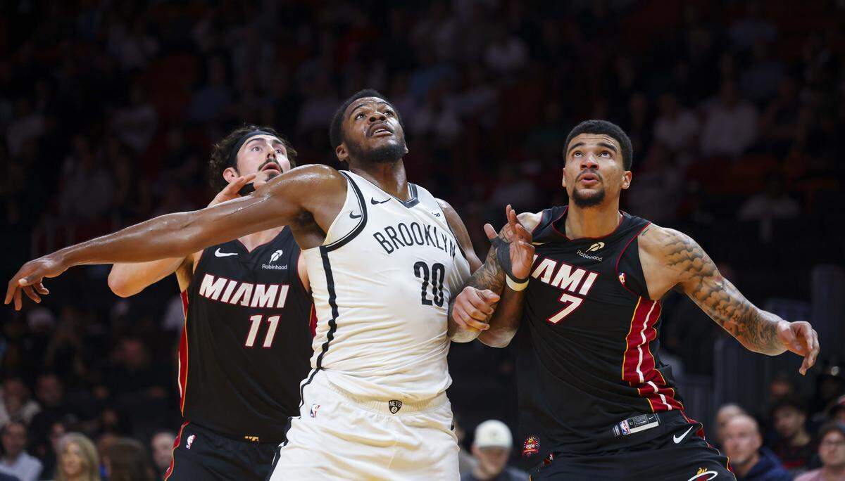 Miami Heat center Kel'el Ware (7) boxes out Brooklyn Nets center Day'ron Sharpe (20) with Miami Heat forward Jaime Jaquez Jr. (11) during the second half of a game on Tuesday, March 3, 2026, at the Kaseya Center in downtown Miami, Fla. 