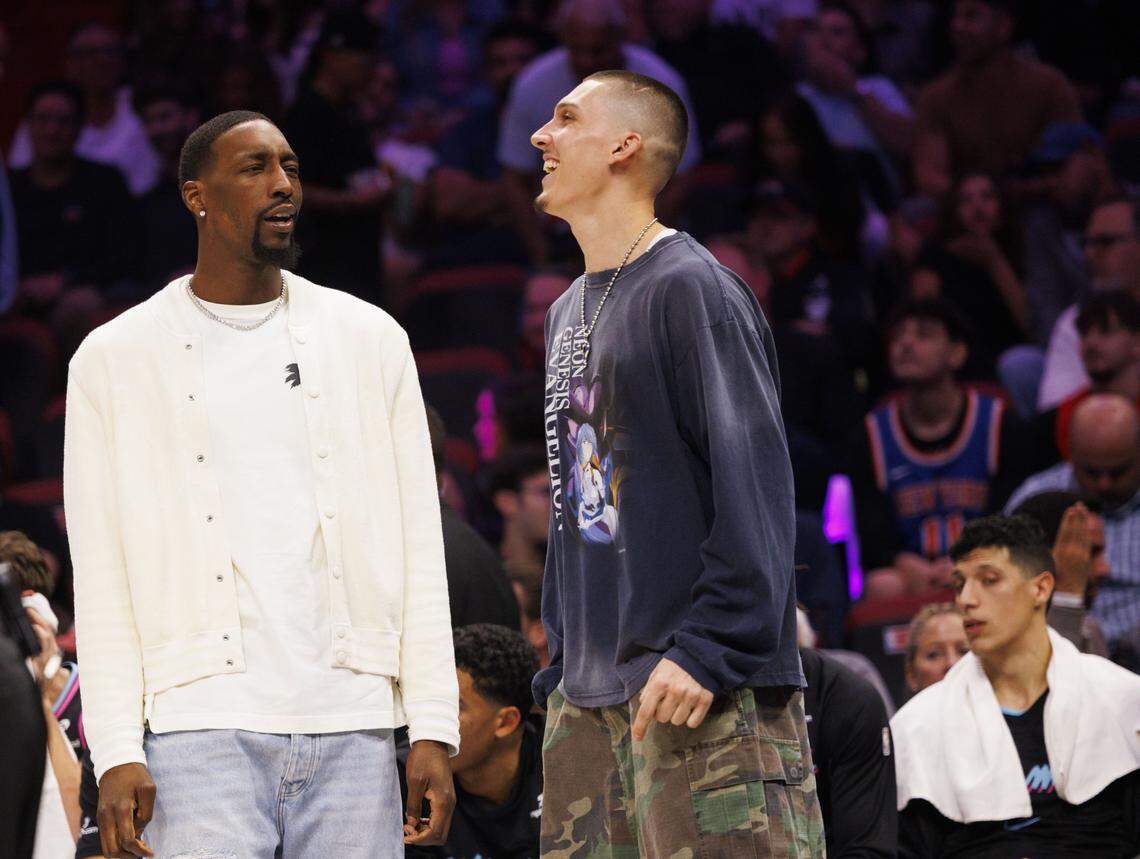 Miami Heat center Bam Adebayo (13) and guard Tyler Herro (14) talk on the bench during the first half of a game against the New York Knicks on Nov. 17, 2025, at Kaseya Center in Miami.