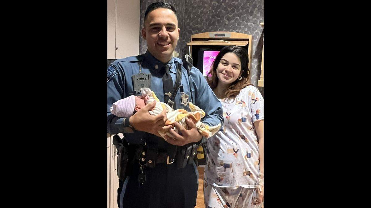 Trooper Jose Cabrera with the newborn boy and the mom he escorted to the hospital after officials say her boyfriend was caught speeding.