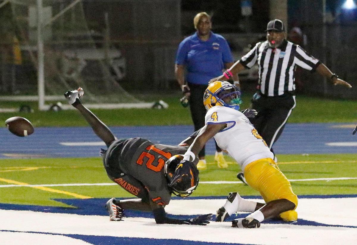 Northwestern Bulls wide receiver Rashad Davis (4) and Booker T. Washington Tornadoes defensive back Ben Hanks Jr. (12) battle for the pass intended for R. Davis during football game on Saturday, October 15, 2022 at Traz Powell Stadium in Miami. Andrew Uloza / for Miami Herald