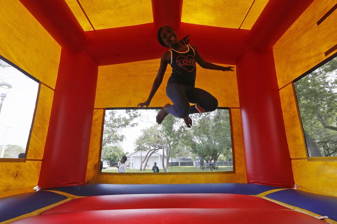 Sheendhainah Romain, 8, in the jumping house at the opening of a new Father Gérard Jean-Juste Community Center at Oak Grove Park.