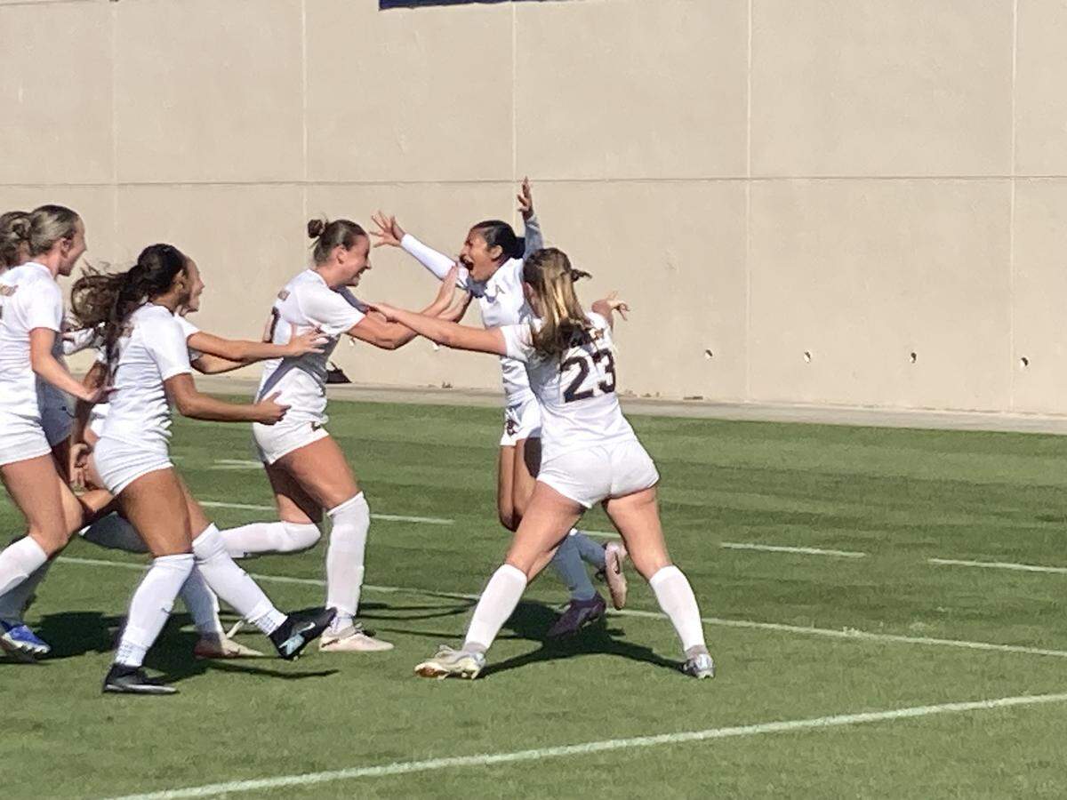 St. Thomas Aquinas players swarm Camila Velez Giraldo after she scored the eventual game-winning goal in the Raiders’ 1-0 win over Niceville on Wednesday in the Class 6A state championship match at Spec Martin Stadium in DeLand, Fla.