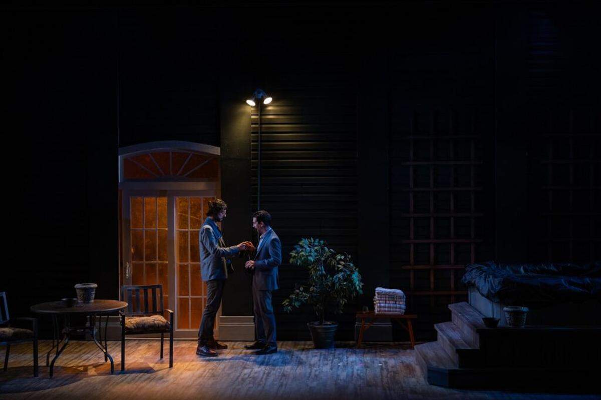 Hale Appleman and Stephen Stocking under the motion activated lights on the back porch set of “Birthright.”