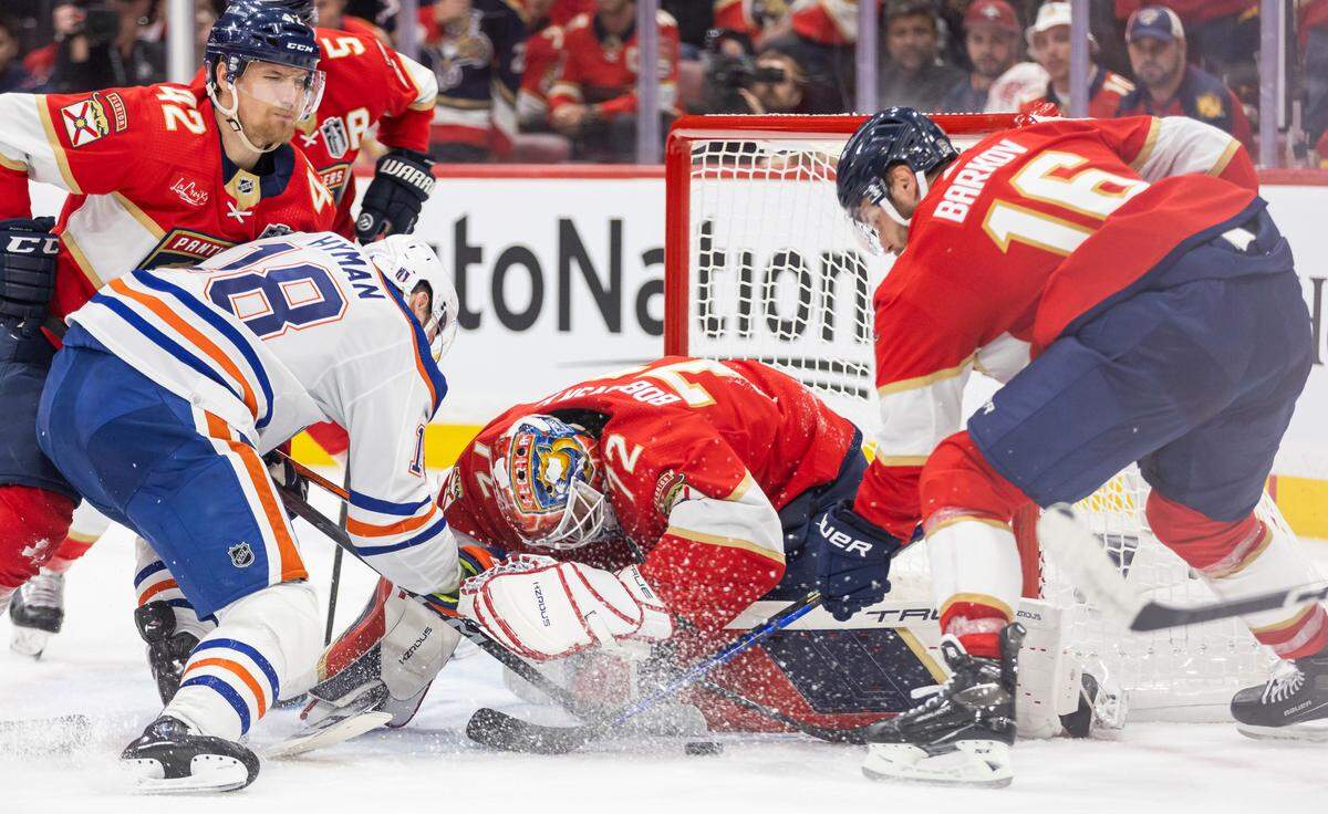 Florida Panthers goaltender Sergei Bobrovsky (72) and center Aleksander Barkov (16) work to stop Edmonton Oilers left wing Zach Hyman (18) from scoring in the second period of Game 1 of the NHL Stanley Cup Finals at the Amerant Bank Arena on Saturday, June 8, 2024, in Sunrise, Fla.