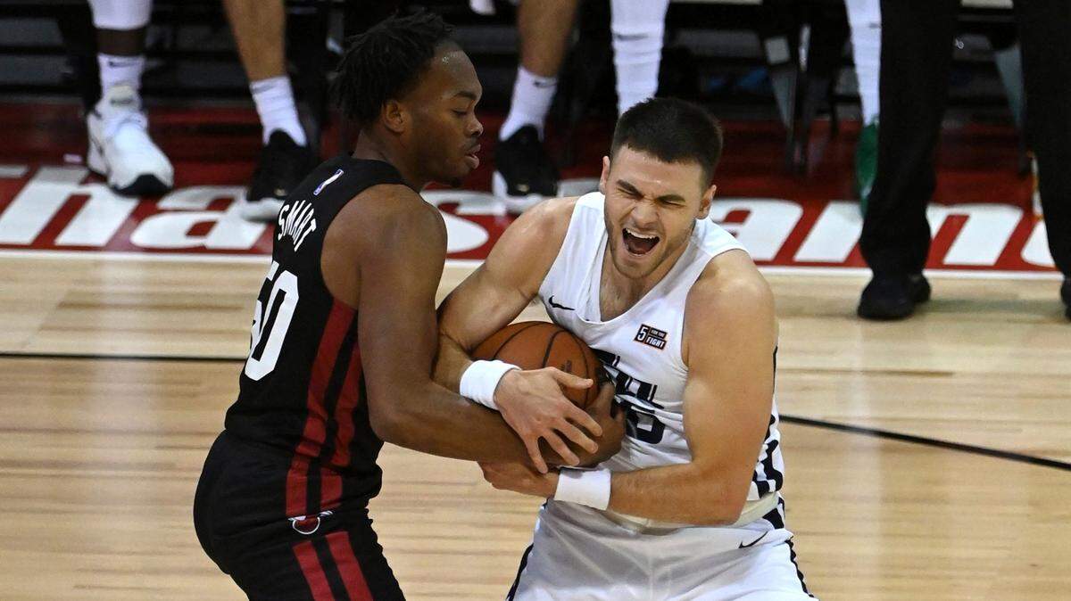Miami Heat guard Javonte Smart (50) and Utah Jazz guard Matt Mooney, right, battle for the ball during the first half of an NBA summer league basketball game Friday, Aug. 13, 2021, in Las Vegas.
