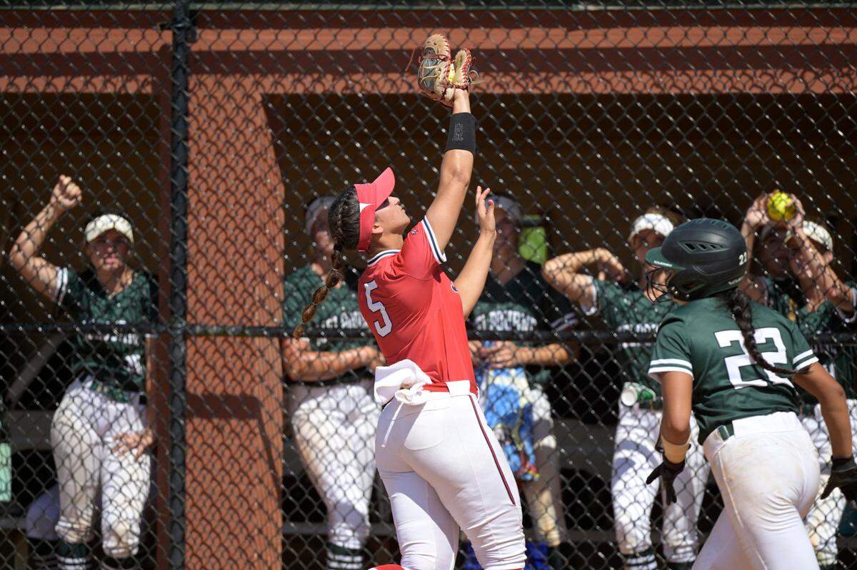 Doral Academy first baseman Ana Richiez (5) catches a popped foul ball from Melbourne’s Nadia English (22) during an FHSAA State Championship Softball Game, Saturday, May 28, 2022, in Clermont, Fla. (Phelan M. Ebenhack for the Miami Herald)