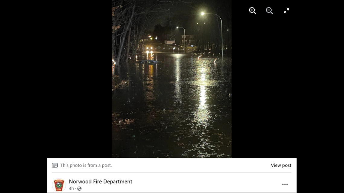 The road was covered in nearly 6 feet of water when a car was spotted sinking, officials said.
