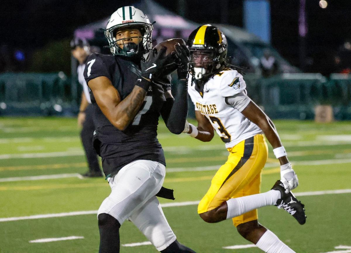 Central’s wide receiver Nae’ Shaun Montgomery (7) catches a pass for a first down as American High’s defensive back Jordan Louis (13) gives chase at Traz Powell Stadium in Miami Friday, September 20, 2024.
