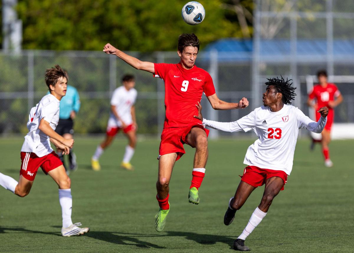 MAST Academy striker Nicolas Alvarez (9) jumps for the header while Key West defender Alan Charles (23) looks on during the 2023 Boy’s soccer playoffs at MAST Academy in Miami, Florida, on Wednesday, February 8, 2023.