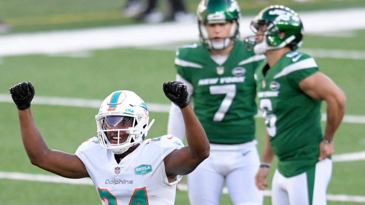 Miami Dolphins’ Byron Jones (24) reacts after New York Jets’ kicker Sergio Castillo, back right, missed a field goal during the first half of an NFL football game, Sunday, Nov. 29, 2020, in East Rutherford, N.J. (AP Photo/Bill Kostroun)