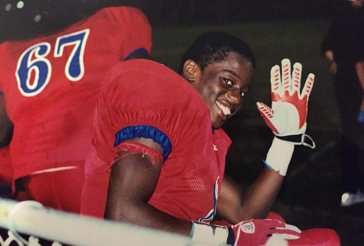 Emmanuel Jean waves in a photo taken in 2004.