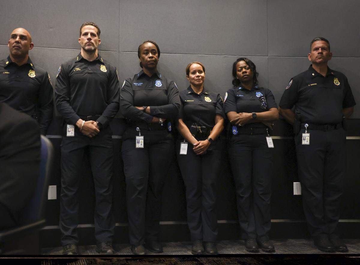 Chief of Police Edwin Lopez, second from the left, stands with members of his staff in the back of a City Council meeting on Wednesday, April 16, 2025, at the Doral Government Center.