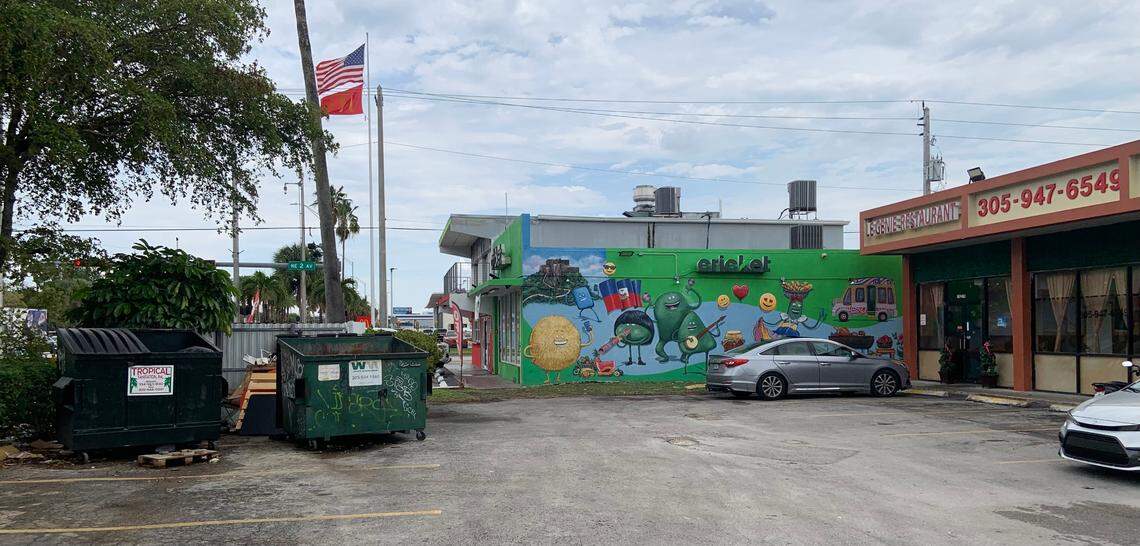 Le Genie Restaurant on the right, dumpsters on the left, open and closer to the front entrance than is healthy.