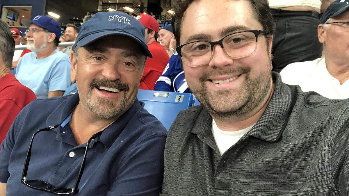 Bradley Maurer and his father, Charles, at a baseball game.