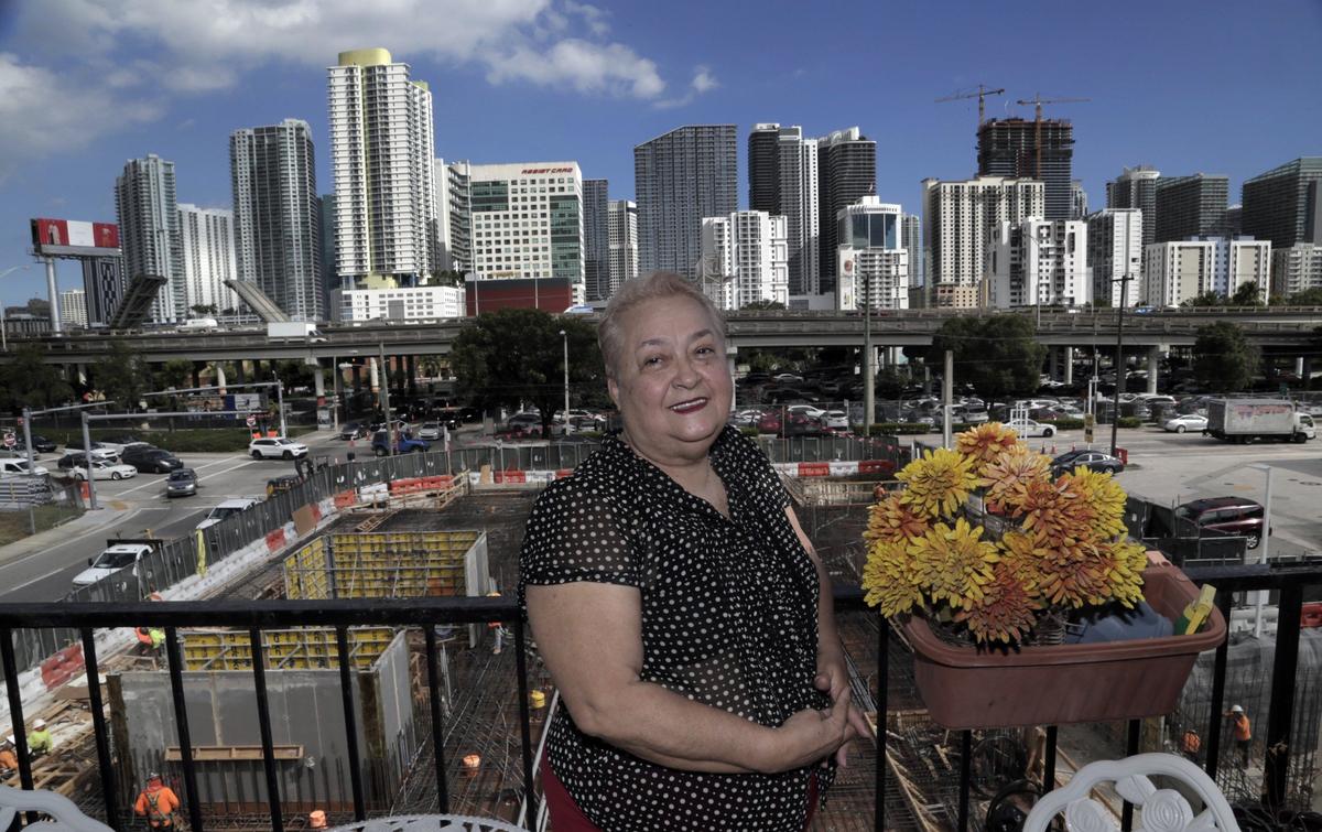 Luz Pabon, a resident of Habana Condos at 424 SW Seventh Street, stands on the balcony of her home, which overlooks Brickell and a massive construction site.