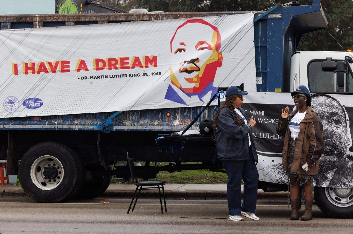Artier Niettles, left, and Gloria Jenkins, workers for the City of Miami Solid Waste Department, talk before the Dr. Martin Luther King Jr. Day parade on Monday, Jan. 20, 2025, in Liberty City in Miami, Fla.