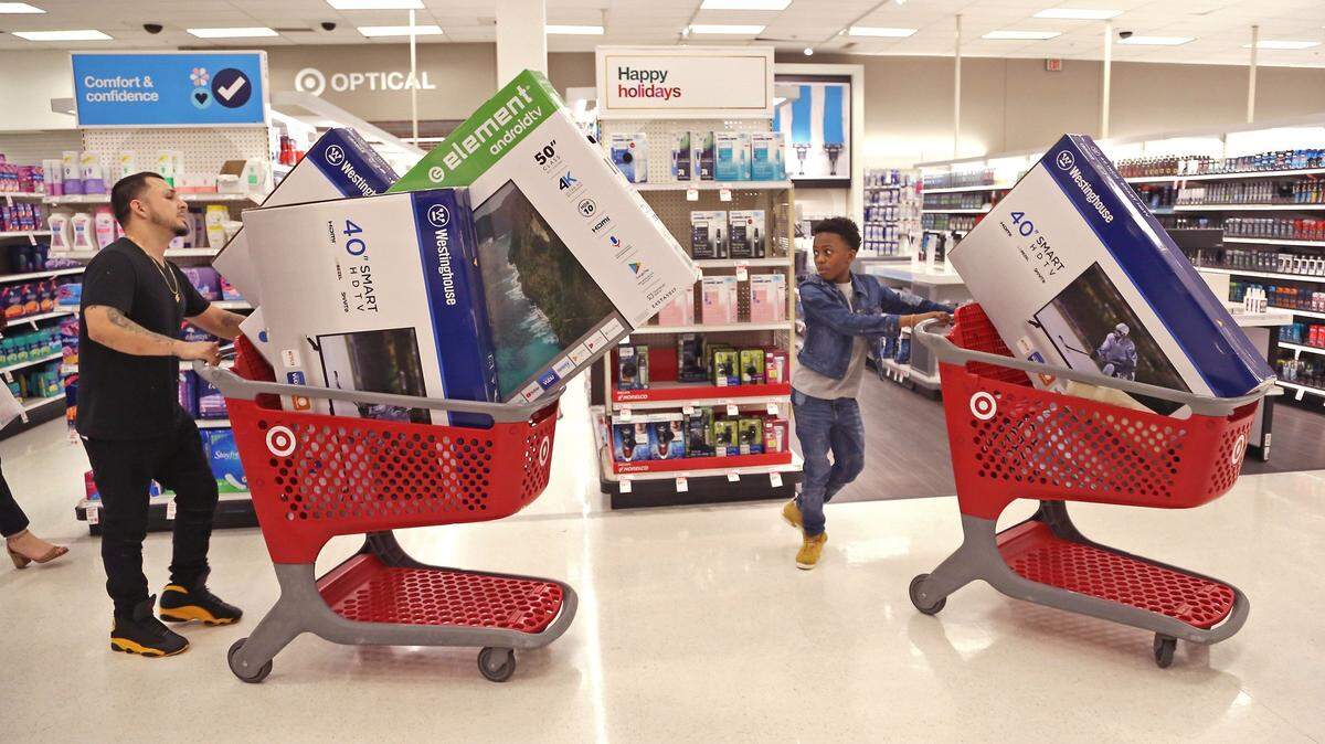 Daniel Cifentes, 36, of Miami, shops for large screen televisions with his stepson, Tavarus Gordon, Jr., at a Walmart in Pembroke Pines at the start of the 2018 holiday shopping season