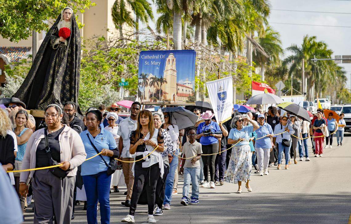 Parishioners from St. Mary Cathedral take part in the Stations of the Cross procession along Northwest Second Avenue on Friday, April 3, 2026, in Miami.