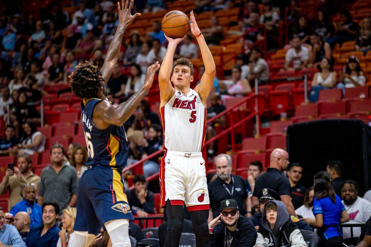 Miami Heat forward Nikola Jovic (5) shoots over New Orleans Pelicans forward Zylan Cheatham (45) during the second half of an NBA preseason game at FTX Arena in Downtown Miami, Florida, on Wednesday, October 12, 2022.