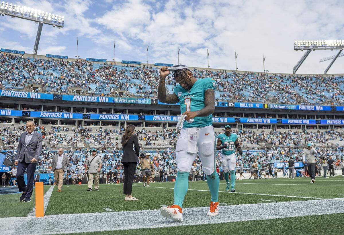 Miami Dolphins quarterback Tua Tagovailoa (1) makes his way off the field after losing to the Carolina Panthers in their NFL game at the Bank of America Stadium on Sunday, Oct. 5, 2025, in Charlotte, N.C.
