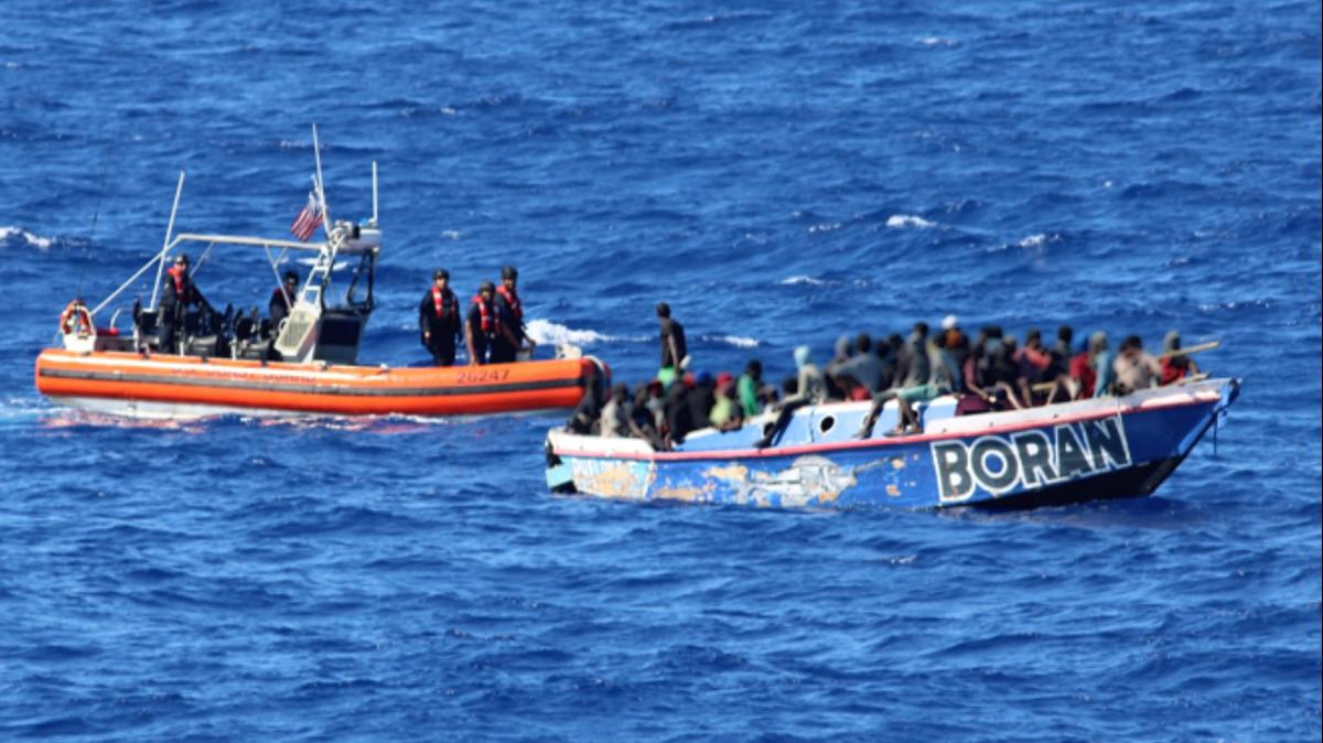 A U.S. Coast Guard patrol boat intercepts an overloaded migrant boat about 35 miles offshore of Haiti Thursday, March 27, 2025.