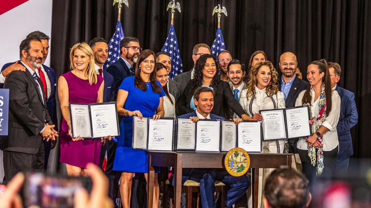 El gobernador Ron DeSantis acompañado de simpatizantes mientras firma varios proyectos de ley de educación en la escuela charter True North Classical Academy, en Miami, el martes 09 de mayo de 2023. 