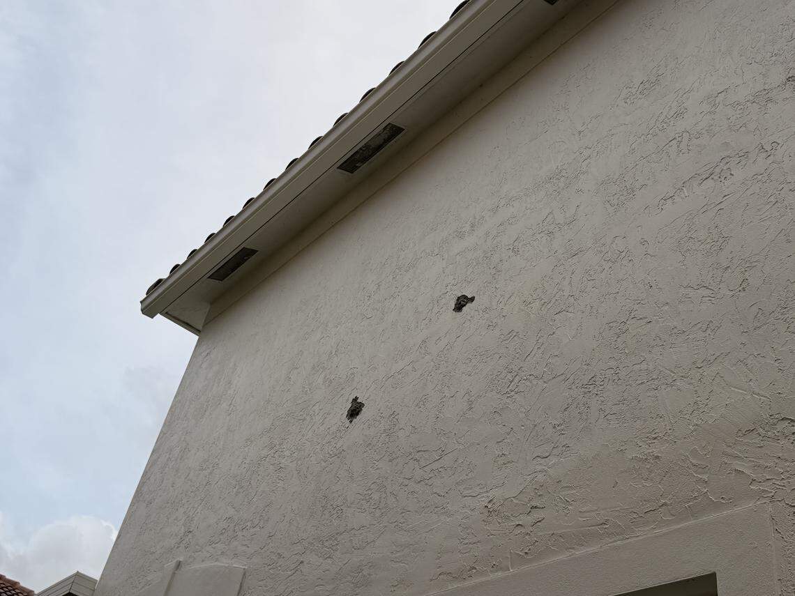Two holes were visible on the second-floor exterior of the home of Nancy Metayer and Stephen Bowen on April 2.