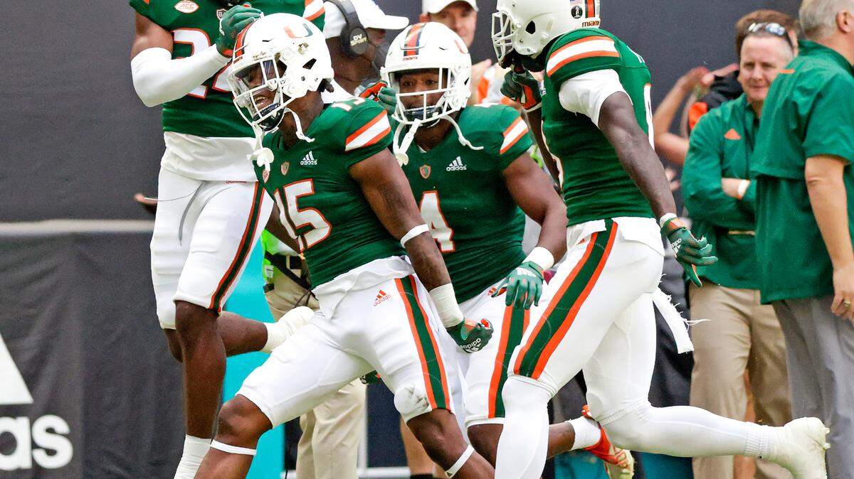 Miami Hurricanes safety Avantae Williams (15) celebrate with teammates after intercepting a pass intended for Georgia Tech Yellow Jackets wide receiver Kyric McGowan (2) during the first quarter of their ACC football game at Hard Rock Stadium on Saturday, November 6, 2021 in Miami Gardens, Florida.