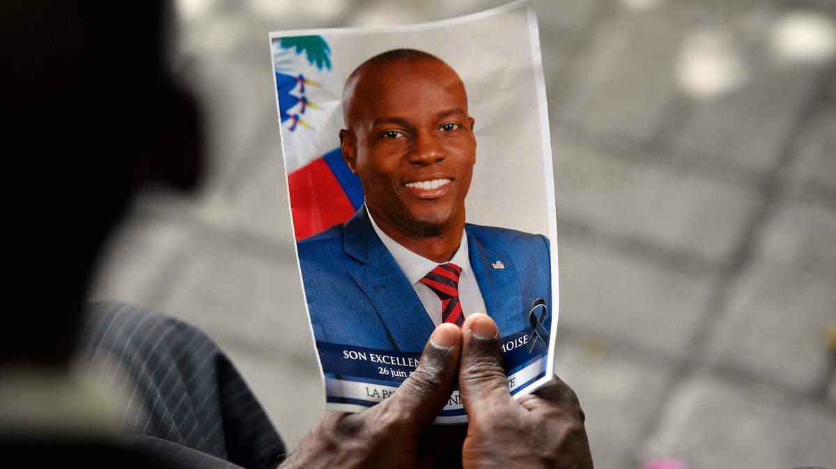 A photo of late Haitian President Jovenel Moïse is held aloft during his memorial ceremony at the National Pantheon Museum in Port-au-Prince, Haiti, July 20, 2021.