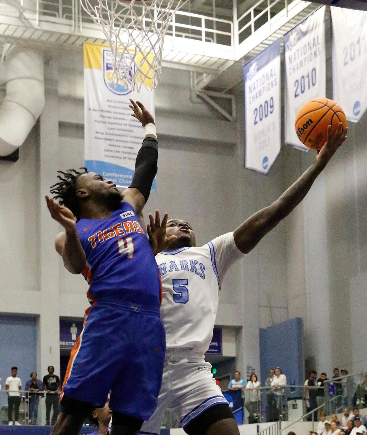 Nova Southeastern’s Sekou Sylla, right, tries to shoot over Savannah State’s Avery Joyner on Saturday. Sylla had a game-high 10 rebounds as the Sharks rolled to the win.