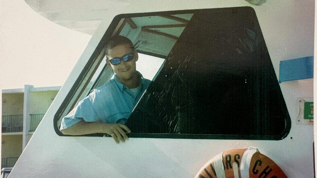 Joseph Hall, Jr. stands in the wheelhouse of his boat, the Sailors Choice.