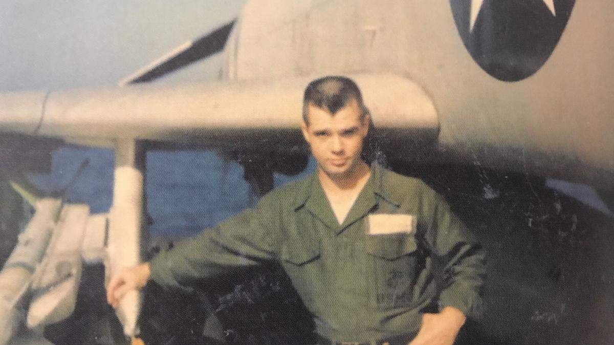 Ed Davidson, then a 27-year-old U.S. Navy captain, stands next to his F-4 II Phantom fighter jet on the deck of the Constellation aircraft carrier off the coast of Vietnam in 1967.