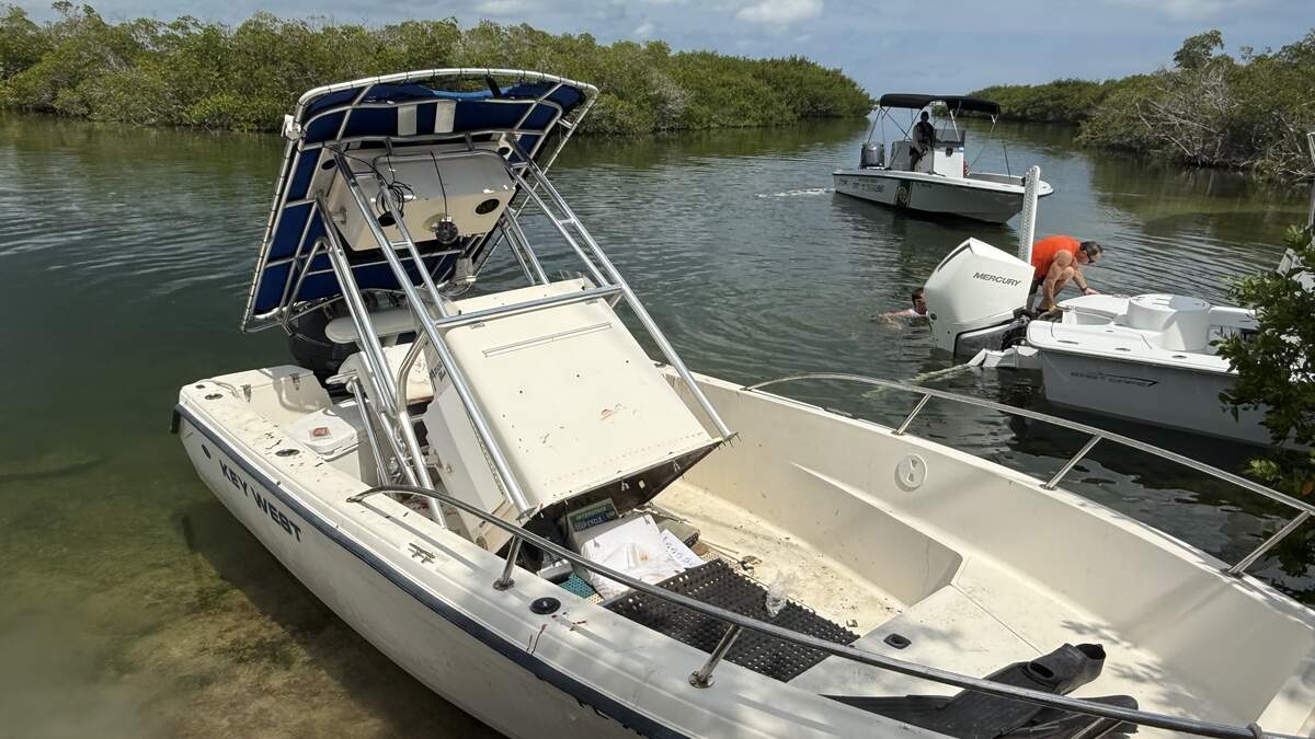 A boat rests in shallow water in the Harris Gap Channel in Sugarloaf Key after hitting a bridge Saturday, July 5, 2026.