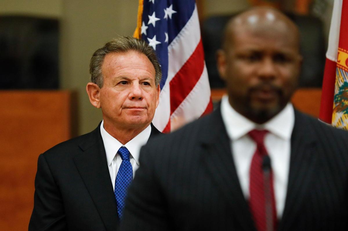 Former Broward Sheriff Scott Israel looks on as Opa-Locka Interim City Manager Darvin Williams speaks to the media after naming Israel as Opa-locka’s new police chief during a press conference at the Sherbondy Village Community Center in Opa Locka, Florida, on Friday, May 6, 2022.