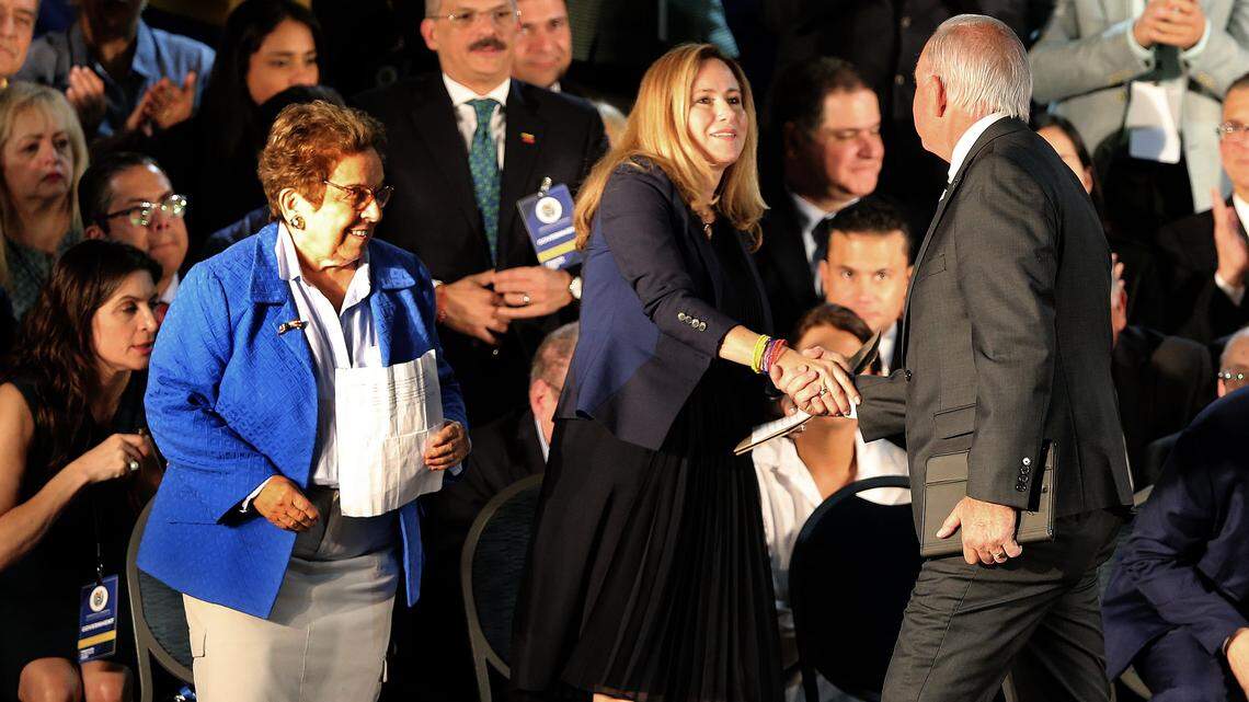 In this file photo, Miami-Dade County Mayor Carlos Gimenez shakes hands with U.S. Rep. Debbie Mucarsel-Powell after he welcomed Venezuela’s interim President Juan Guaidó at a rally to meet with the exiled Venezuelan community during his visit to Miami on Saturday, Feb. 1, 2020.