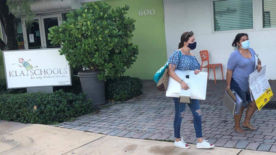 Irene Correa and Raquel Moreno leave the KLA school with some teaching materials on Monday Sept. 6 , 2021, after a judge allowed employees to return to a building that was locked up by the new owner, citing chemical hazards from the dry cleaner next door. KLA said in a court filing its own environmental expert found no health hazards at the prime property in the Brickell Avenue neighborhood, off the Miami River.