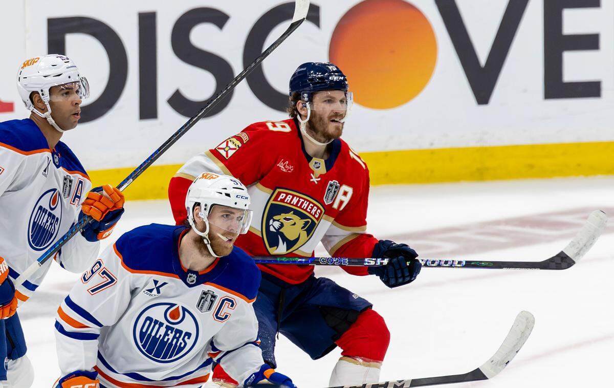 Florida Panthers left wing Matthew Tkachuk (19) battles against Edmonton Oilers center Connor McDavid (97) and defenseman Darnell Nurse (25) during the first period of Game 4 in the Stanley Cup Final at Amerant Bank Arena on Thursday, June 12, 2025, in Sunrise, Fla.