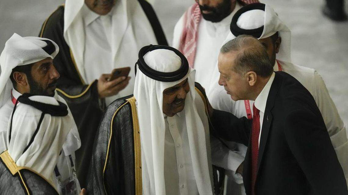 Former Emir of Qatar Sheikh Hamad bin Khalifa Al Thani, center, and Turkish President Recep Tayyip Erdogan greet each other before the start of the World Cup on Nov. 20.