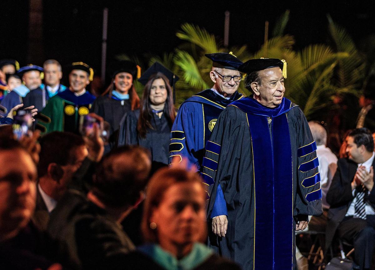 Former FIU presidents Modesto A. Maidique, front, and Mark Rosenberg, walk in the opening procession of the FIU presidential investiture ceremony, Thursday May 18 , 2023.