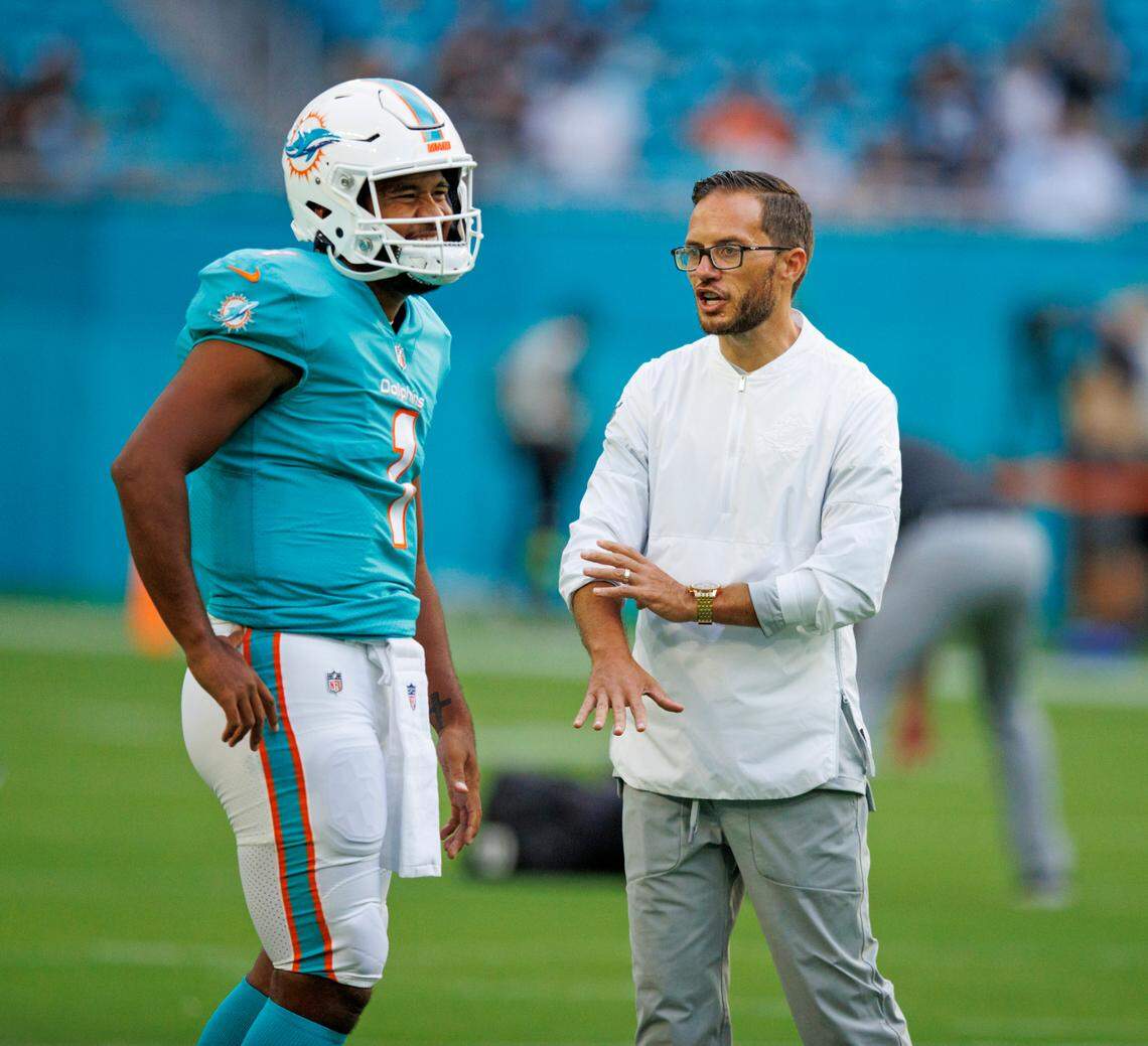 Miami Dolphins quarterback Tua Tagovailoa (1) talks with Dolphins head coach Mike McDaniel before the start of a NFL preseason football game against the Las Vegas Raiders at Hard Rock Stadium on Saturday, August 20, 2022 in Miami Gardens, Florida.