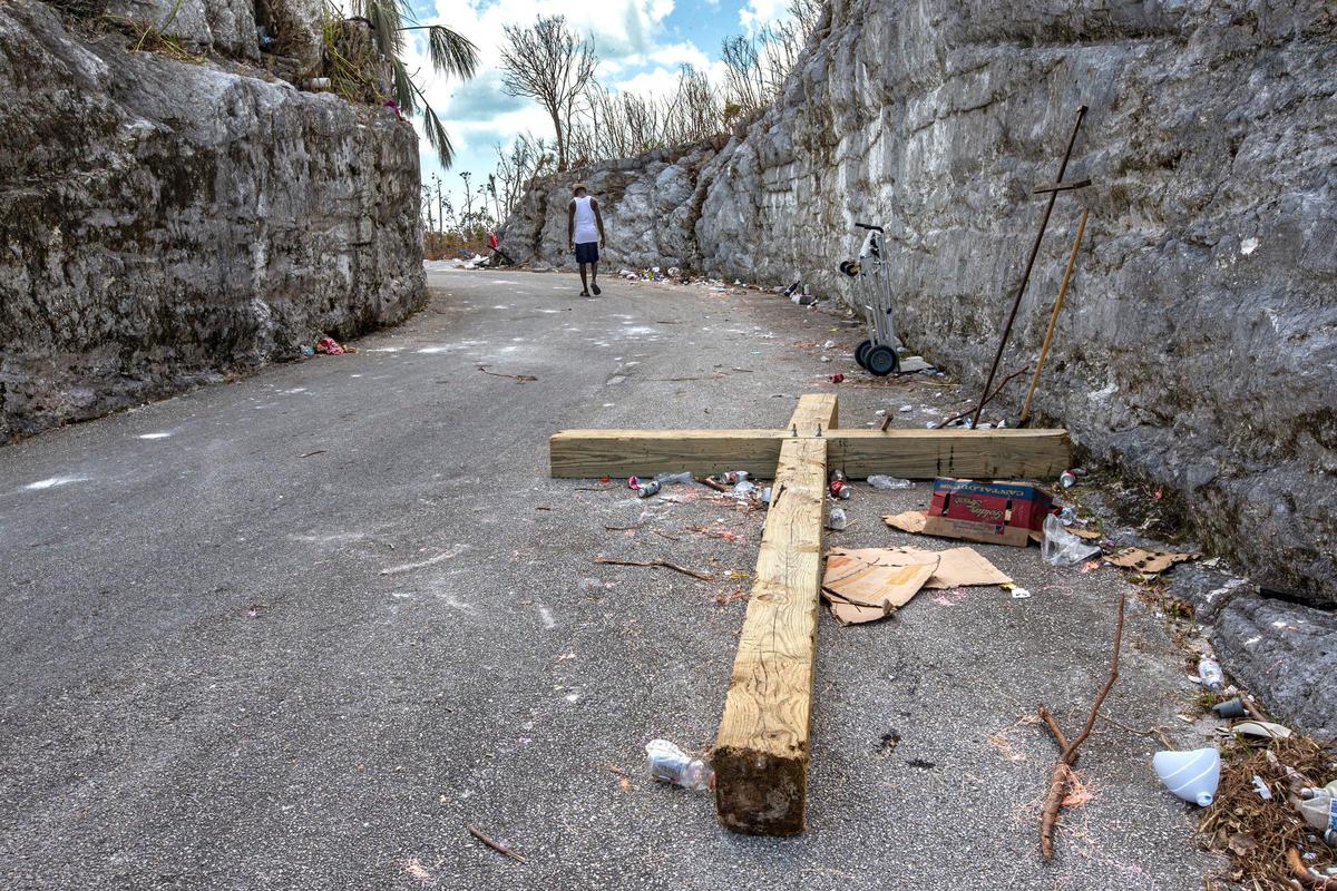 A wooden cross lays on the side of the road after Hurricane Dorian ripped it off the hilltop outside Saint Francis Catholic Church in Marsh Harbour on Abaco Island on Saturday, September 7, 2019.