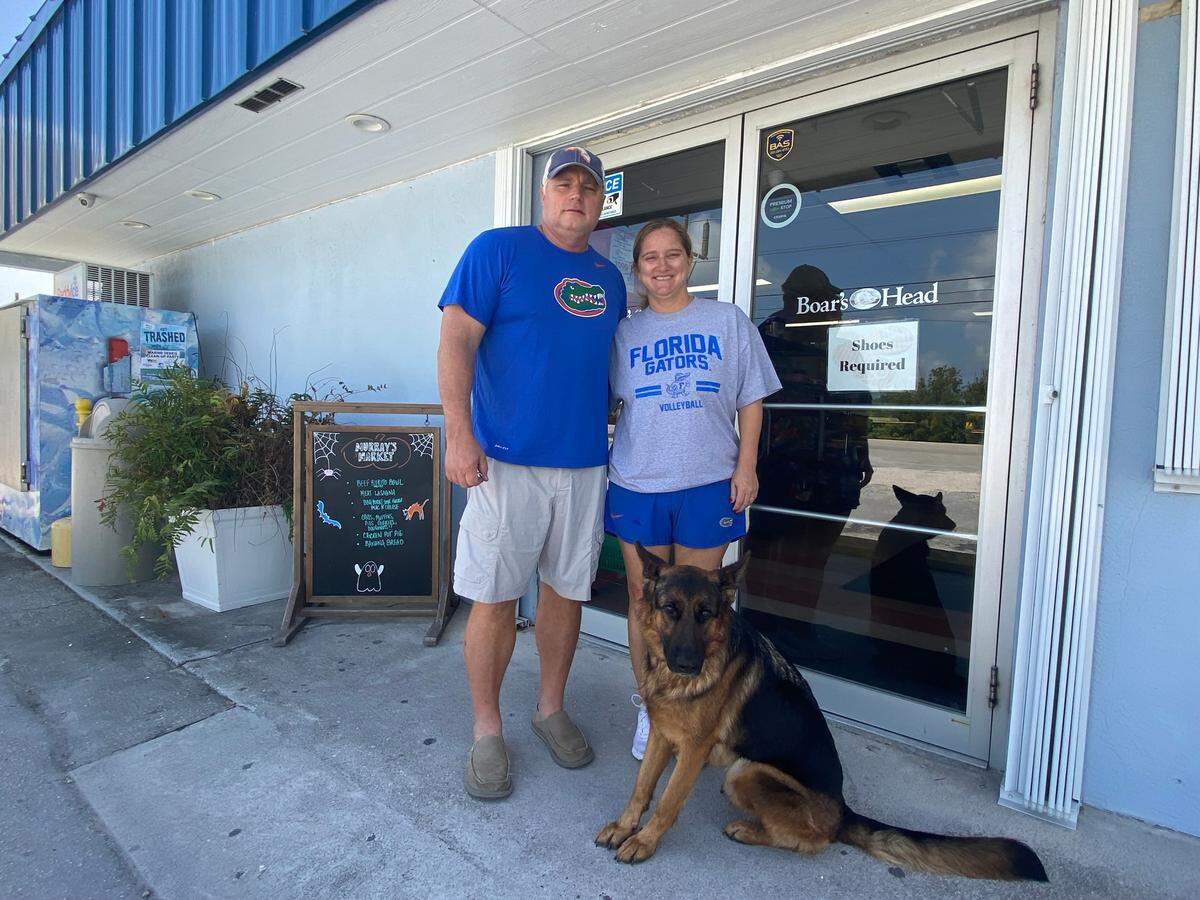 Drew and Ginny Haggard own Murray’s Market on Summerland Key in the Florida Keys. They posed in front of the business with their dog Lucy on Oct. 9, 2021.