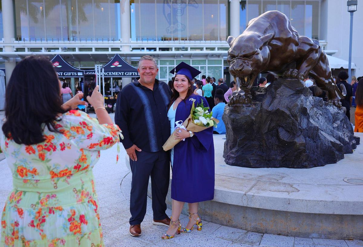 Michelle Mendez hugs her father, Martin Mendez, as her stepmother, Ivette Gomez, takes a photo. With her newly acquired degree in interdisciplinary studies, the 27-year-old graduate wants to launch a career in human resources. “This is spectacular. It’s so joyful; it’s no nice to see everyone,” Gomez said. “And were so proud of her.”