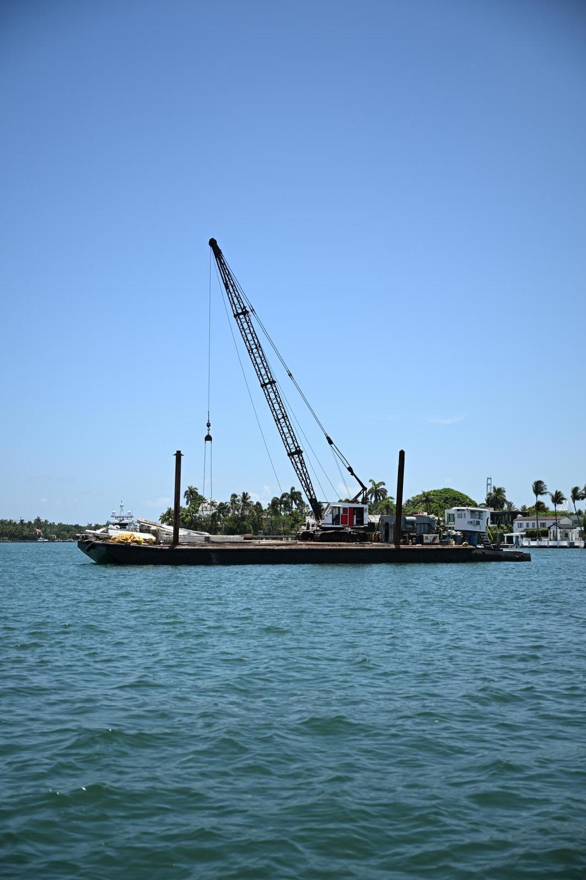 A barge floats off Hibiscus Island near Miami Beach Monday, July 28, 2025. The vessel struck a sailboat earlier in the day. Two children on the sailboat died in the hospital, and another two were critically injured, the Coast Guard said. Two other girls on the sailboat, which was part of a Miami Yacht Club summer camp program, were rescued.  