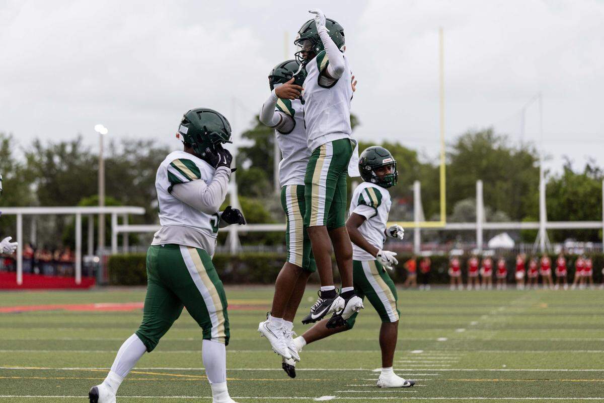 Mater Academy quarterback Nate Merrell Jr. reacts with wide receiver Marcus Dumont (1) after scoring a touchdown during the first half of a high school football game at Doral Academy on Thursday, August 28, 2025, in Doral, Fla.